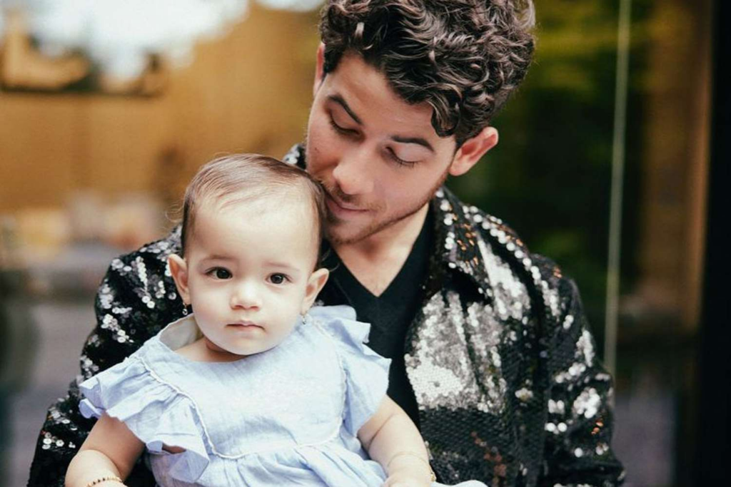 Nick Jonas with his baby